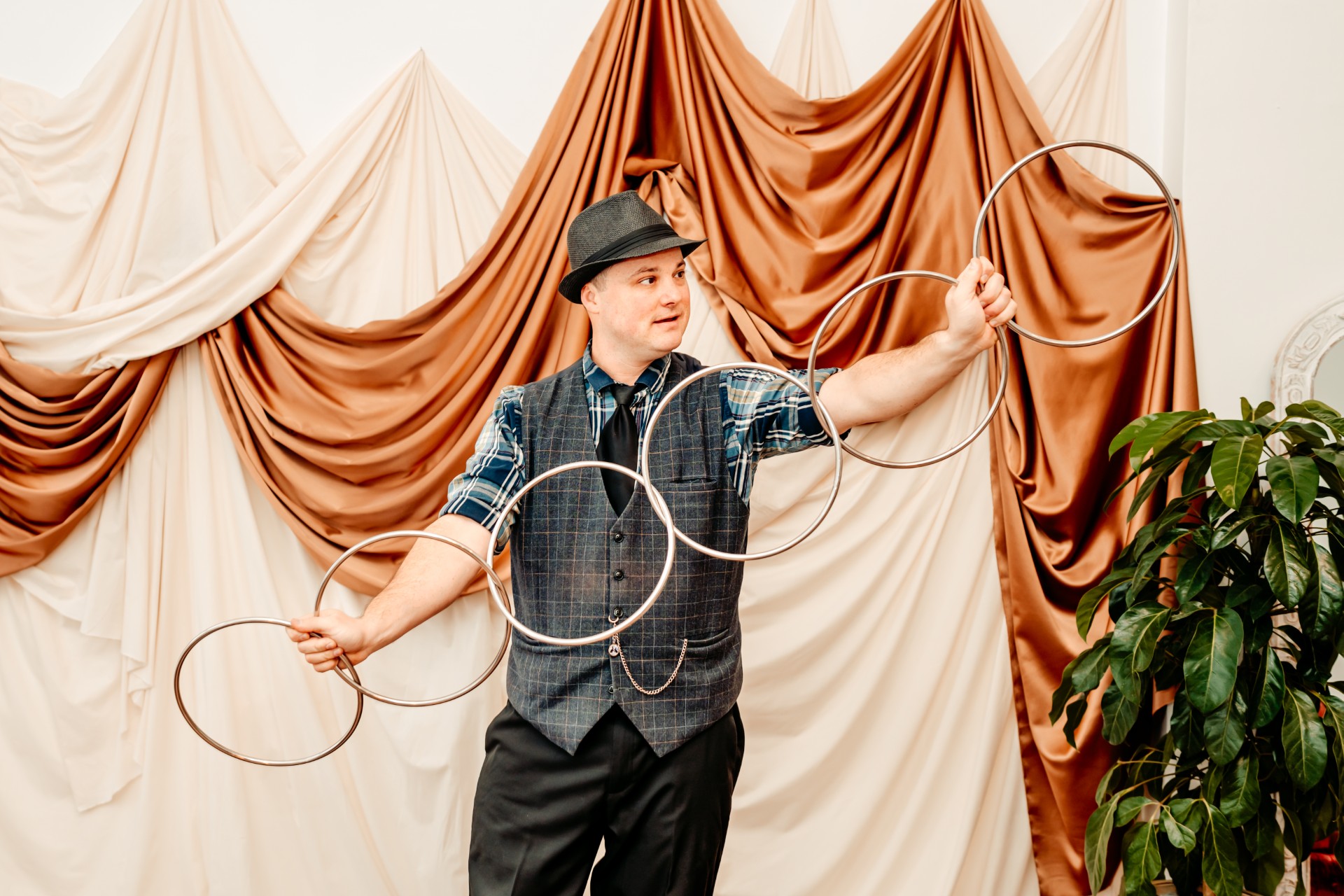 Magic Nate on stage with six connected rings