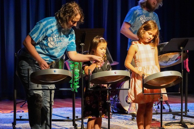 Steel Appeal performer and some kids