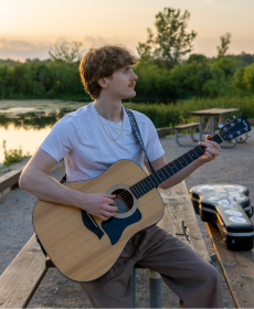 Calvin holding a guitar