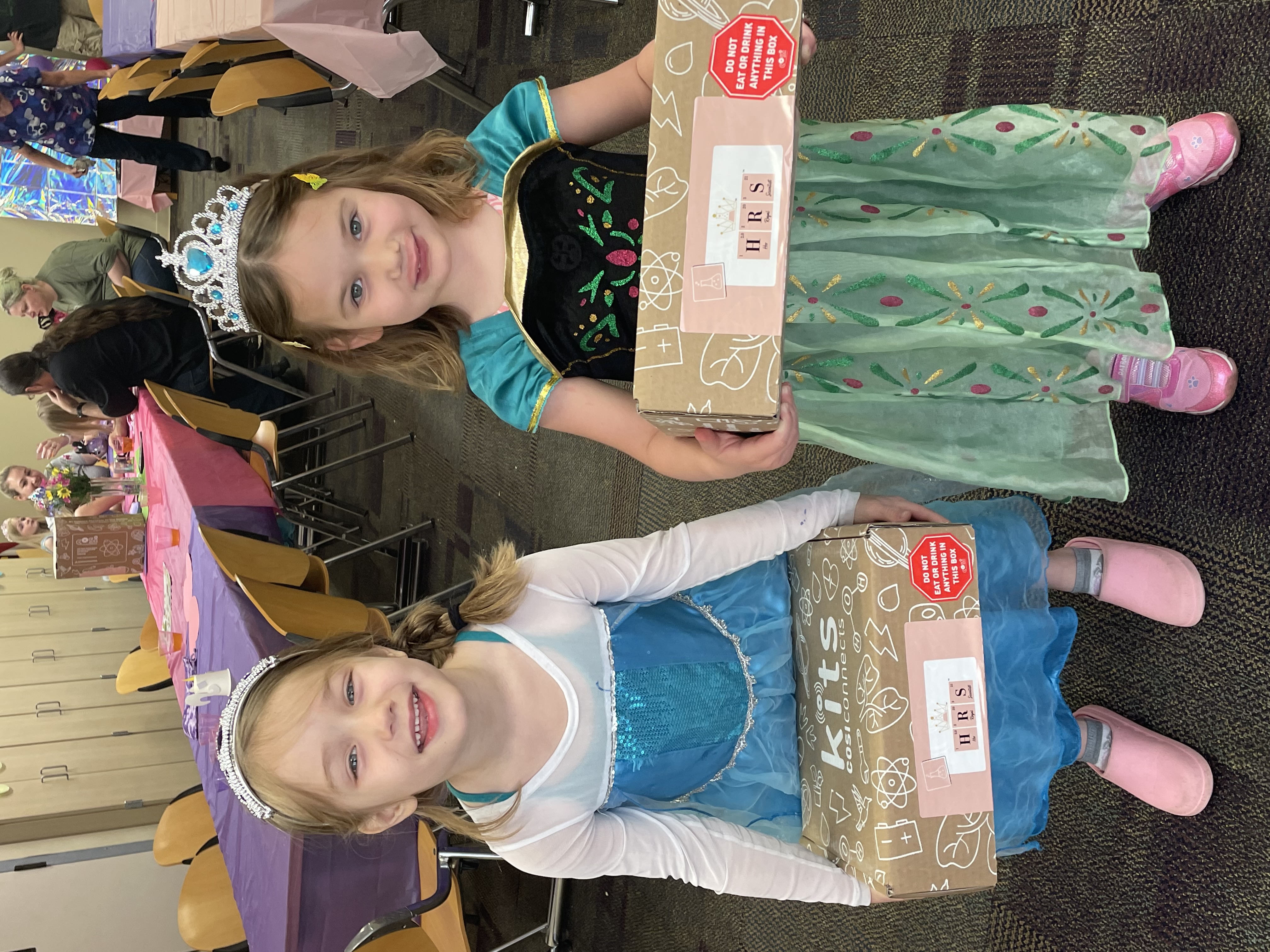 2 princesses holding COSI kits