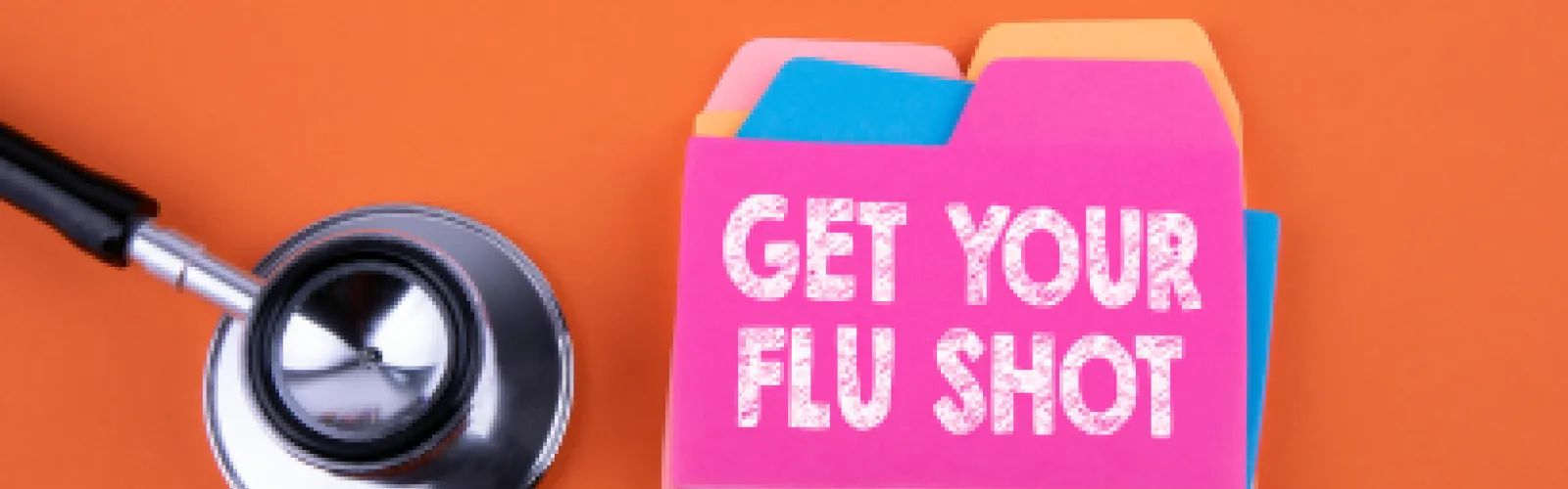 folders with "Get your flu shot" on them. stethoscope with an orange background